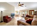 Inviting living room with tile flooring, ceiling fan, and comfortable seating arrangement at 20739 N 106Th Ave, Peoria, AZ 85382
