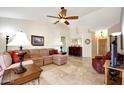 Spacious living room with tile floors, ceiling fan, and stylish furnishings at 20739 N 106Th Ave, Peoria, AZ 85382