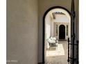 Inviting courtyard with neutral palette, arched entry, tile flooring, and comfortable seating at 2121 E Aquarius Pl, Chandler, AZ 85249