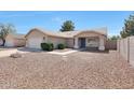 A single-story house with a desert-style front yard offers low maintenance, complemented by a detached garage at 23638 N 41St Ave, Glendale, AZ 85310