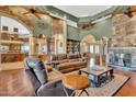 Spacious living room with high ceilings, stone accent wall, and beautiful hardwood floors at 2371 E Sanoque Ct, Gilbert, AZ 85298