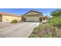 Single-Gathering home with desert landscaping, well-maintained bushes, and a spacious two-car garage at 24035 W La Salle St, Buckeye, AZ 85326