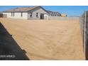 Large, undeveloped backyard space awaiting personalization and landscaping at 25489 W Fraktur Rd Rd, Buckeye, AZ 85326