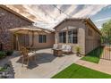 Inviting backyard setting with patio furniture, green turf, and string lights for outdoor enjoyment at 2554 E Honeysuckle Pl, Chandler, AZ 85286