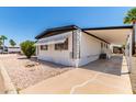 Quaint mobile home with a covered awning, a well-kept rock yard and driveway with desert landscaping at 2650 W Union Hills Dr # 269, Phoenix, AZ 85027