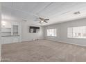 Spacious living room with neutral walls, carpet, bright light and a ceiling fan at 2650 W Union Hills Dr # 269, Phoenix, AZ 85027