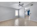 Spacious living area with neutral color palette, tile flooring, and natural light at 3178 W Williams Dr, Phoenix, AZ 85027