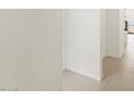 Bright hallway featuring neutral wall paint, leading to additional living spaces at 37168 W Prado St, Maricopa, AZ 85138