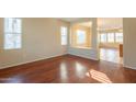 Bright and spacious living room featuring wood floors and natural light from large windows at 4010 W Fremont Rd, Phoenix, AZ 85041