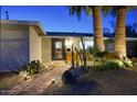 Beautiful brick pathway to front door with unique desert landscaping at dusk at 4714 N Miller Rd, Scottsdale, AZ 85251