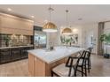 Bright kitchen featuring a large island, stainless steel appliances, and seamless access to dining area at 6069 E Ironwood Dr, Scottsdale, AZ 85266