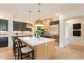 Beautiful kitchen boasts ample counter space, custom cabinetry, and a modern island for seating at 6069 E Ironwood Dr, Scottsdale, AZ 85266