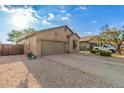 Single-story home features a two-car garage, rock landscaping, and desert plants in a well-maintained front yard at 6520 E Hacienda La Noria Ln, Gold Canyon, AZ 85118