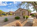 Landscaped single-story home featuring desert landscaping, a two-car garage, and a well-maintained front yard at 6520 E Hacienda La Noria Ln, Gold Canyon, AZ 85118