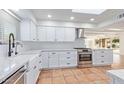 Bright and modern kitchen features white cabinetry, stainless steel appliances, and stylish countertops at 6615 E Desert Cove Ave, Scottsdale, AZ 85254