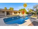 Inviting pool area with lush landscaping, patio, and charming backyard for outdoor entertaining at 6615 E Desert Cove Ave, Scottsdale, AZ 85254