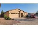 Well-maintained single-story home with desert landscaping, a two-car garage, and a concrete driveway at 6820 S 68Th Ln, Laveen, AZ 85339
