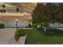 Charming home featuring a terra cotta tile roof, lush landscaping, and a well-manicured lawn at 7114 E Buena Terra Way, Paradise Valley, AZ 85253