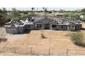 Exterior view of a house under construction, featuring roofing materials and stucco work at 8125 E Gail Rd, Scottsdale, AZ 85260