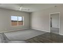 Large living room showcasing new flooring, neutral colored carpet and ample natural light at 8284 W Mccartney Rd, Casa Grande, AZ 85194