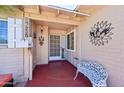 Inviting front porch with address numbers, decor, and a decorative metal bench at 8637 E Solano Dr, Scottsdale, AZ 85250