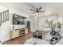 Bright living room featuring hardwood floors, modern furnishings and a ceiling fan at 9050 N 51St Ln, Glendale, AZ 85302