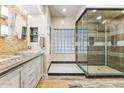 Spa-like bathroom with double sink, stone accents, and a large glass shower at 1073 N Layman St, Gilbert, AZ 85233