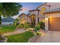 Beautiful house exterior with landscaped yard, garden, lush greenery, and a two-car garage at 1073 N Layman St, Gilbert, AZ 85233