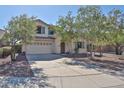 Charming two-story home featuring a well-manicured lawn, mature trees and a spacious two car garage at 1114 S 220Th Ave, Buckeye, AZ 85326