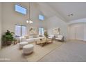 Bright and airy living room featuring vaulted ceilings, neutral tones, and modern furniture at 1114 S 220Th Ave, Buckeye, AZ 85326