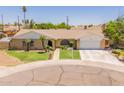 Inviting single-story home with a green lawn and a convenient two-car garage at 1186 E Brenda Dr, Casa Grande, AZ 85122