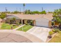 Single-story home with a tidy front lawn, desert landscaping, and a two-car garage at 1186 E Brenda Dr, Casa Grande, AZ 85122