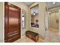 Welcoming entryway with tiled floor, bench seating, and view to home office at 12903 W Brookhart Way, Peoria, AZ 85383
