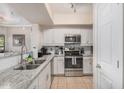 Well-equipped kitchen with white cabinets, granite counters, and stainless steel appliances at 15095 N Thompson Peak Pkwy # 1005, Scottsdale, AZ 85260