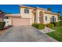 Two-story home featuring a two-car garage and desert landscaping at 15211 N 89Th Ave, Peoria, AZ 85381