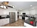 Bright kitchen featuring white cabinets, granite countertops, stainless steel appliances, and tile flooring at 1640 W Gail Dr, Chandler, AZ 85224