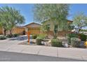 Charming single-Gathering home with desert landscaping, rocks, and beautiful trees at 18108 W Thunderhill Pl, Goodyear, AZ 85338