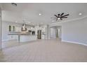 Open-concept kitchen featuring white cabinets, granite countertops, and stainless steel appliances at 18108 W Thunderhill Pl, Goodyear, AZ 85338