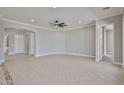 An open-concept living room space with tile floors and a ceiling fan at 18108 W Thunderhill Pl, Goodyear, AZ 85338