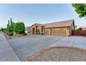 Expansive property with a three-car garage, desert landscaping, and wide driveway at 1849 S 96Th St, Mesa, AZ 85209