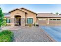 Charming single-story home featuring a three-car garage and desert landscaping at 1849 S 96Th St, Mesa, AZ 85209