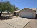 Charming single-story home featuring a well-manicured front yard and a two-car garage at 1918 S Ocotillo Dr, Apache Junction, AZ 85120