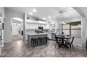 Bright kitchen with white cabinets, tiled backsplash, stainless appliances and eat-in nook at 2111 E Rawhide St, Gilbert, AZ 85296