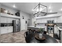 Modern kitchen with stainless steel appliances, white cabinetry, and center island at 2111 E Rawhide St, Gilbert, AZ 85296
