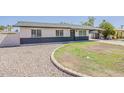 Inviting single-story home with decorative rock landscaping and covered carport, showing great curb appeal at 2130 W Cindy St, Chandler, AZ 85224