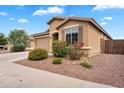 Inviting single-story home featuring a two-car garage and low maintenance desert landscaping at 2264 W Arroyo Way, San Tan Valley, AZ 85144