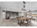 Open concept kitchen and living room with island seating and stainless steel appliances at 2264 W Arroyo Way, San Tan Valley, AZ 85144