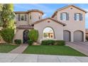 Elegant two-story home featuring a circular tower, arched entryway, dark shutters and a manicured lawn at 26036 N 85Th Dr, Peoria, AZ 85383