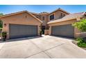 Exterior view of a home with a three-car garage, inviting entrance, and well-maintained landscaping at 2759 E Balsam Dr, Chandler, AZ 85286