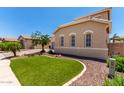 Landscaped front yard with artificial turf, rock features, and desert landscaping offering low maintenance appeal at 2759 E Balsam Dr, Chandler, AZ 85286